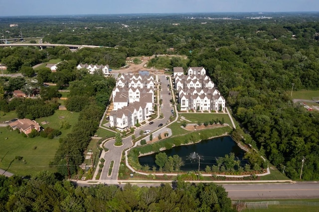 bird's eye view with a wooded view and a water view