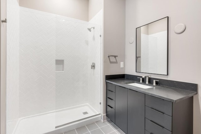 full bath featuring a stall shower, tile patterned floors, and vanity