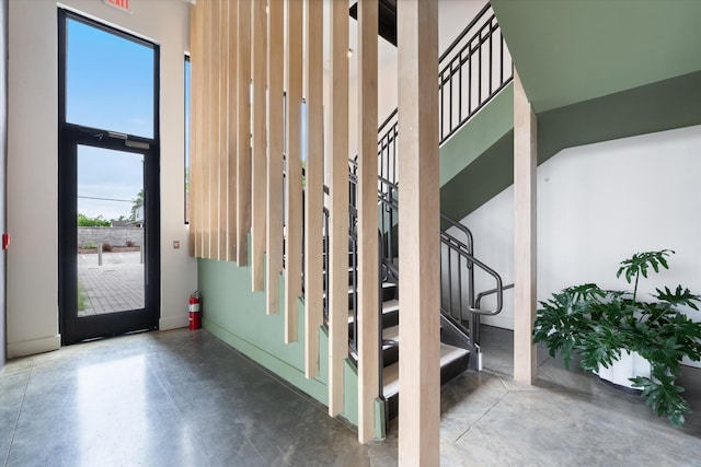 detailed view of finished concrete flooring, a fire extinguisher, and baseboards