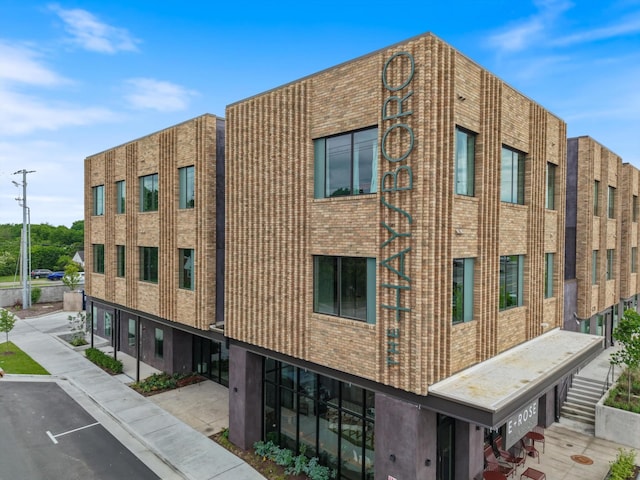 view of building exterior featuring uncovered parking