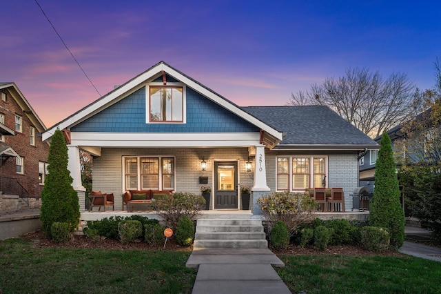 2510 Belmont Blvd, Nashville, TN 37212 - view of front of home with a front lawn, brick siding, an outdoor living space, and covered porch