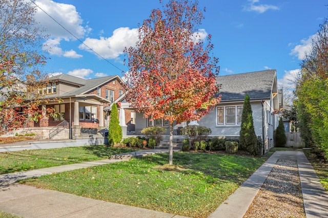 2510 Belmont Blvd, Nashville, TN 37212 - view of front of property featuring a porch, a shingled roof, a front lawn, and brick siding