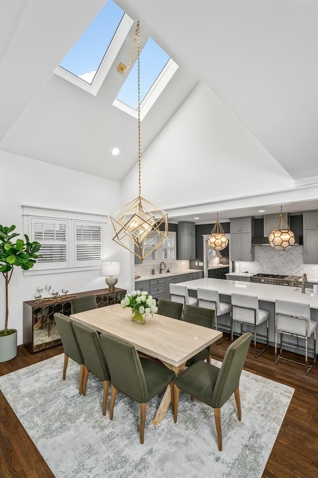 2510 Belmont Blvd, Nashville, TN 37212 - dining area featuring high vaulted ceiling, a notable chandelier, dark wood-type flooring, and a skylight