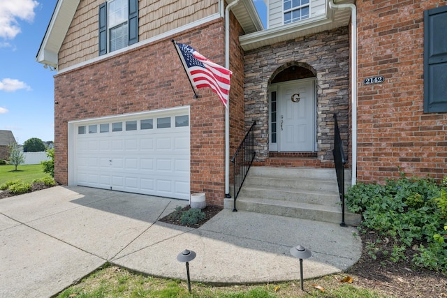 2142 Gold Valley Dr, Murfreesboro, TN 37130 - view of exterior entry featuring brick siding, an attached garage, and concrete driveway