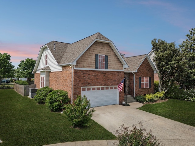 2142 Gold Valley Dr, Murfreesboro, TN 37130 - view of front of house featuring brick siding, a garage, a lawn, and driveway