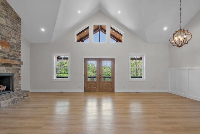 327 Turkey Creek Highway, Carthage, TN 37030 - unfurnished living room with high vaulted ceiling, light wood-style flooring, an inviting chandelier, and a fireplace