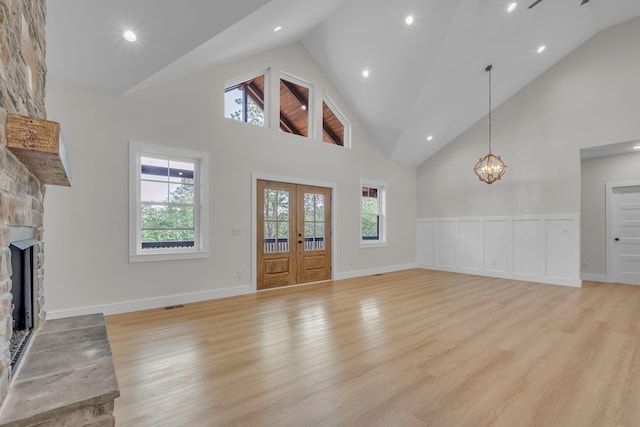327 Turkey Creek Highway, Carthage, TN 37030 - unfurnished living room featuring a fireplace, light wood-style flooring, a wealth of natural light, and high vaulted ceiling