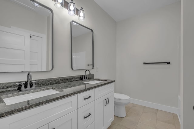 327 Turkey Creek Highway, Carthage, TN 37030 - bathroom featuring toilet, double vanity, a sink, and baseboards