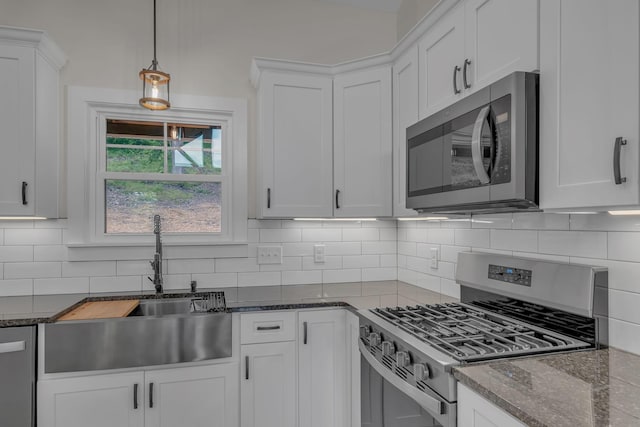 327 Turkey Creek Highway, Carthage, TN 37030 - kitchen featuring appliances with stainless steel finishes, white cabinetry, backsplash, and a sink
