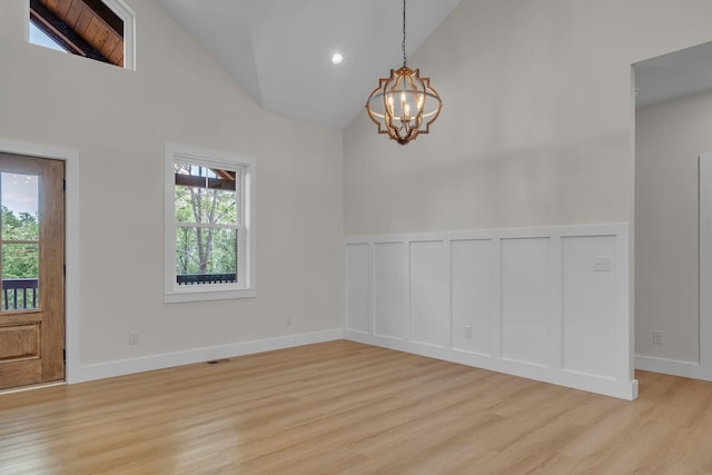 327 Turkey Creek Highway, Carthage, TN 37030 - interior space featuring high vaulted ceiling, a notable chandelier, light wood-style floors, and a decorative wall