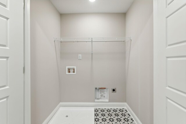 laundry area with baseboards, washer hookup, hookup for an electric dryer, and laundry area