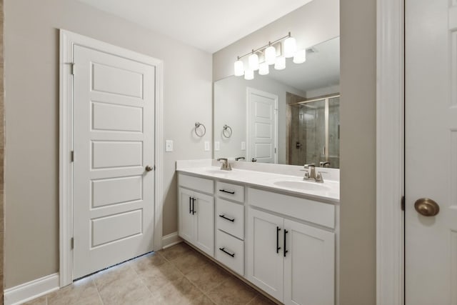 bathroom featuring a shower stall, tile patterned floors, a sink, and double vanity