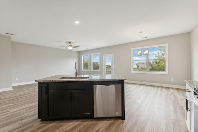 kitchen with stainless steel dishwasher, open floor plan, a sink, and visible vents