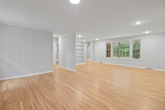 unfurnished living room with recessed lighting, light wood-type flooring, visible vents, and baseboards