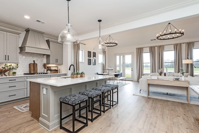 3222 Hopetown Way, Murfreesboro, TN 37129 - kitchen featuring custom range hood, gray cabinets, a sink, a chandelier, and backsplash