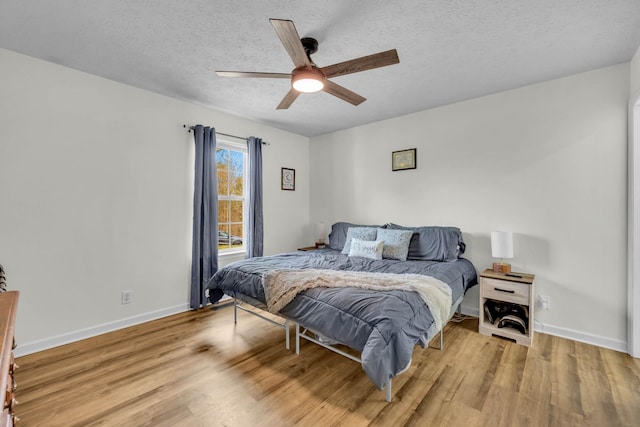 369 Talpha Dr, Dowelltown, TN 37059 - bedroom featuring a ceiling fan, baseboards, a textured ceiling, and light wood-style floors