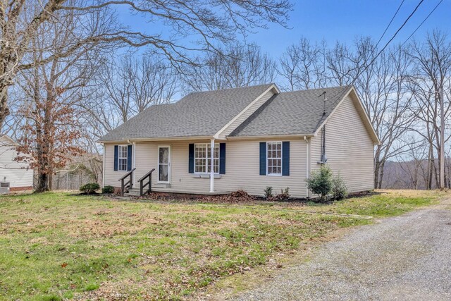 369 Talpha Dr, Dowelltown, TN 37059 - ranch-style house featuring a front lawn and roof with shingles