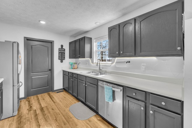 369 Talpha Dr, Dowelltown, TN 37059 - kitchen with light wood finished floors, light countertops, a sink, and appliances with stainless steel finishes