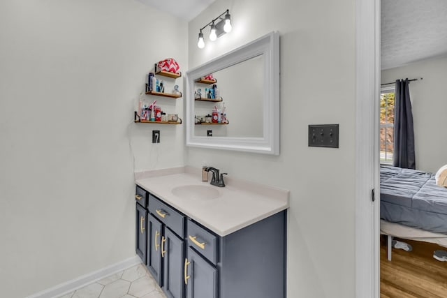 369 Talpha Dr, Dowelltown, TN 37059 - bathroom featuring baseboards, tile patterned flooring, vanity, and ensuite bathroom