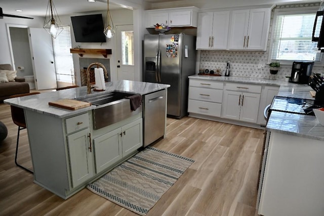 4310 Memory Ln, Adams, TN 37010 - kitchen featuring appliances with stainless steel finishes, a sink, healthy amount of natural light, and white cabinetry