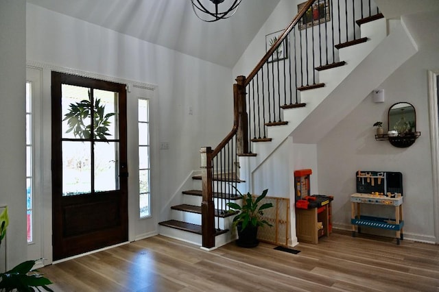 4310 Memory Ln, Adams, TN 37010 - foyer entrance with stairway, wood finished floors, high vaulted ceiling, and baseboards