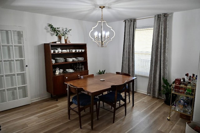 4310 Memory Ln, Adams, TN 37010 - dining area with a chandelier, wood finished floors, and baseboards