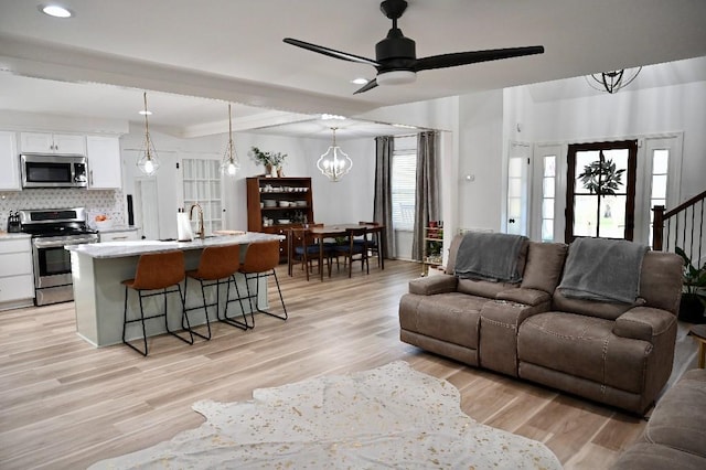 4310 Memory Ln, Adams, TN 37010 - living area featuring light wood-style floors, a ceiling fan, a chandelier, and recessed lighting