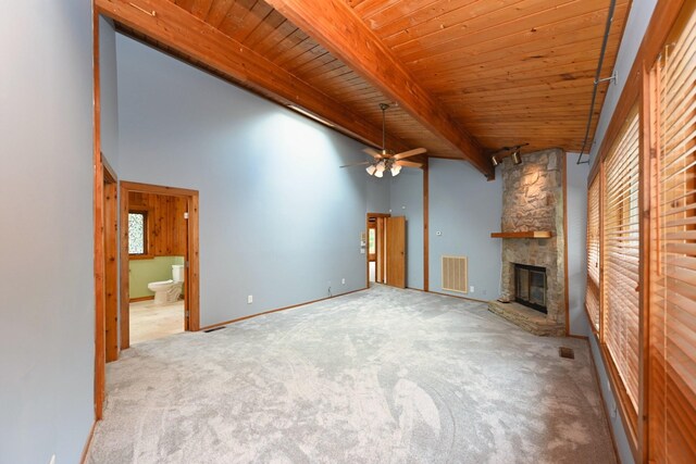 1061 Ridgecrest Dr, Goodlettsville, TN 37072 - unfurnished living room featuring a fireplace, carpet, beam ceiling, a ceiling fan, and wooden ceiling