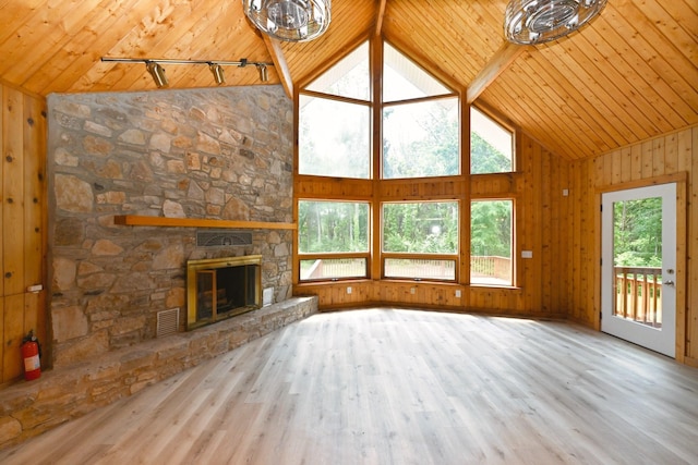 1061 Ridgecrest Dr, Goodlettsville, TN 37072 - unfurnished living room featuring wood ceiling, wood finished floors, high vaulted ceiling, a fireplace, and beamed ceiling
