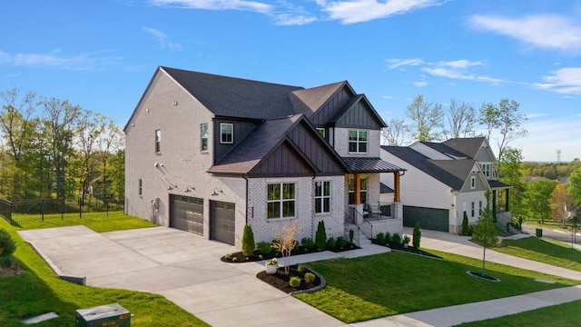 view of front facade with board and batten siding, brick siding, a front lawn, concrete driveway, and an attached garage