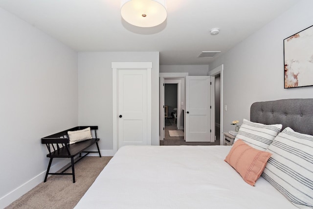 carpeted bedroom with baseboards and visible vents