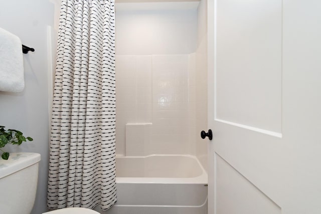 bathroom with toilet and shower / tub combo with curtain