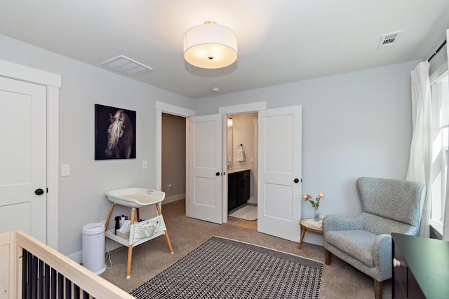 bedroom with visible vents, baseboards, and light carpet