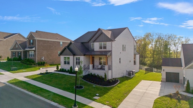 view of front of property featuring covered porch, board and batten siding, central AC unit, a front lawn, and concrete driveway