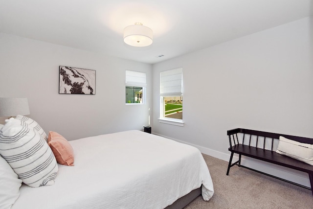 carpeted bedroom with baseboards