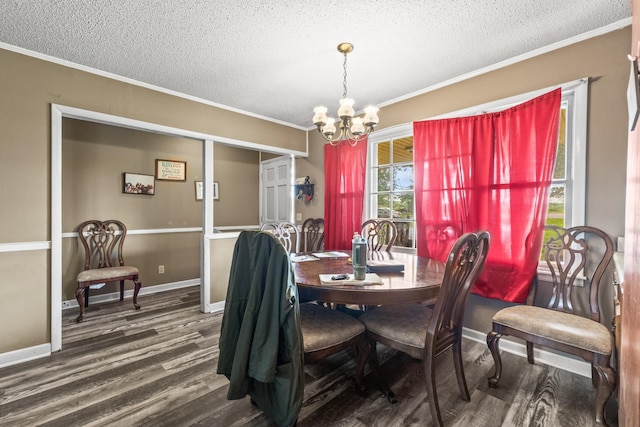 dining space with ornamental molding, a textured ceiling, a chandelier, and dark wood finished floors