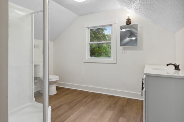 full bath featuring vaulted ceiling, a textured ceiling, and wood finished floors