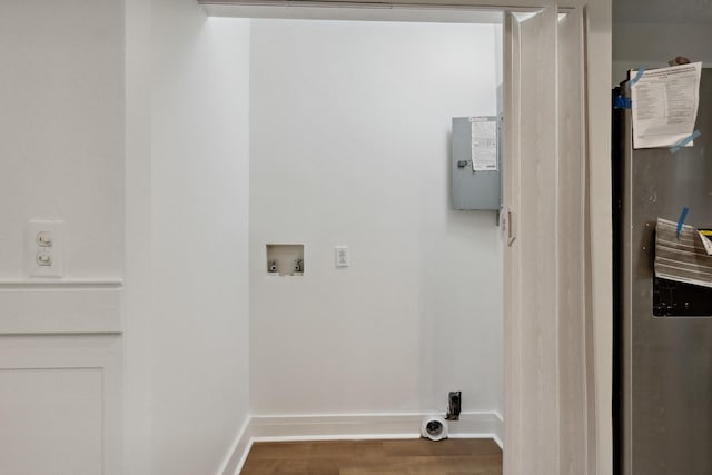 washroom featuring baseboards, wood finished floors, hookup for a washing machine, and laundry area
