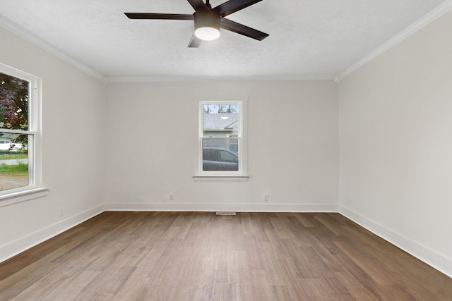 unfurnished room featuring ceiling fan, baseboards, wood finished floors, and ornamental molding