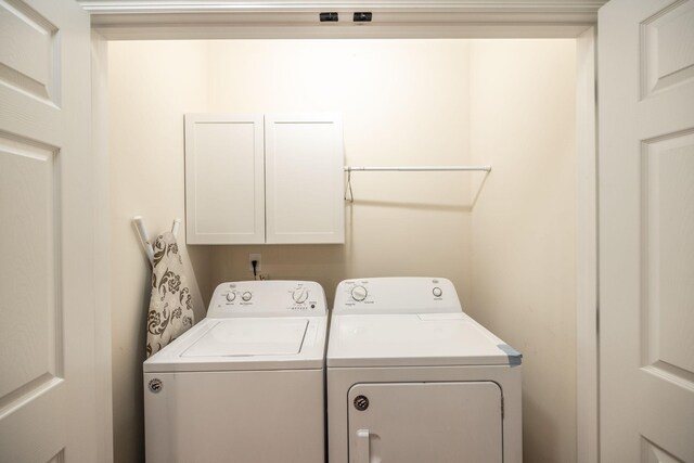laundry area with washer and dryer and cabinet space