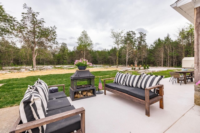 view of patio with an outdoor living space, a view of trees, and outdoor dining area