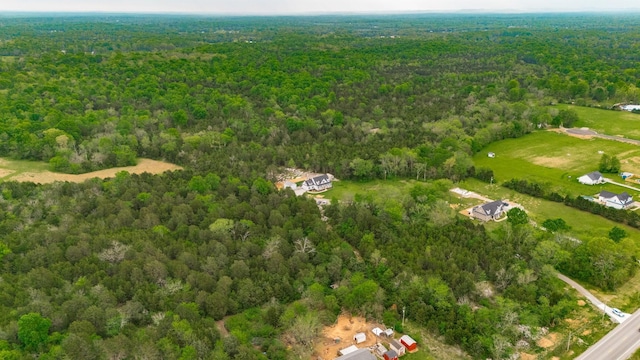 birds eye view of property with a wooded view