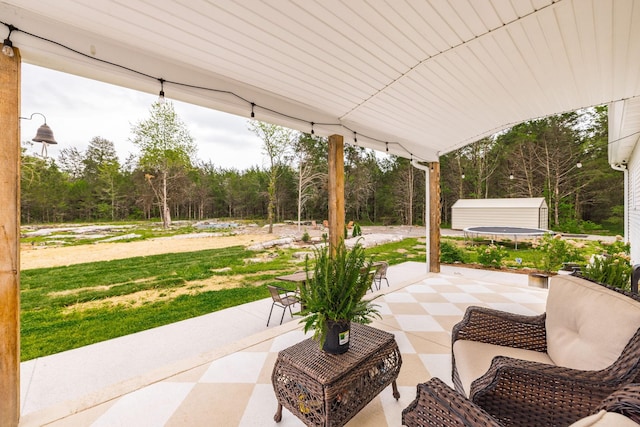 view of patio with an outbuilding and a shed