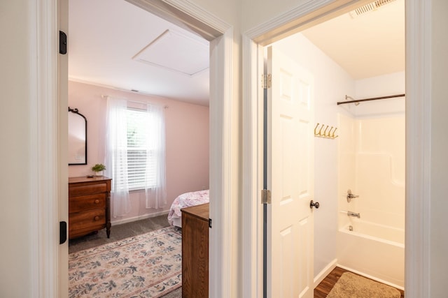 bathroom with baseboards, vanity, visible vents, and shower / tub combination