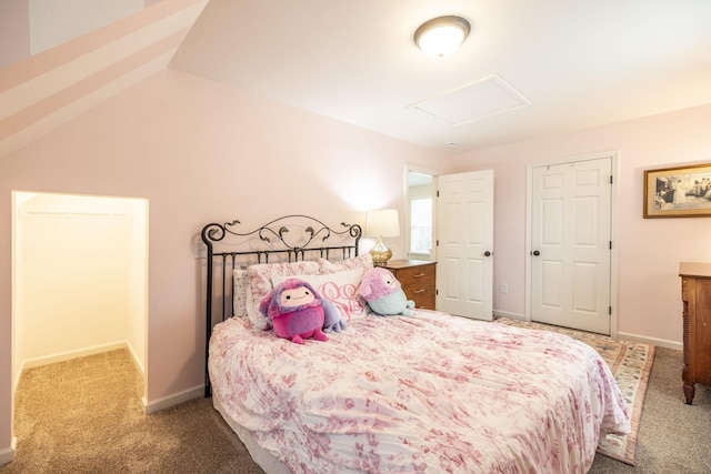 bedroom featuring attic access, baseboards, and carpet flooring