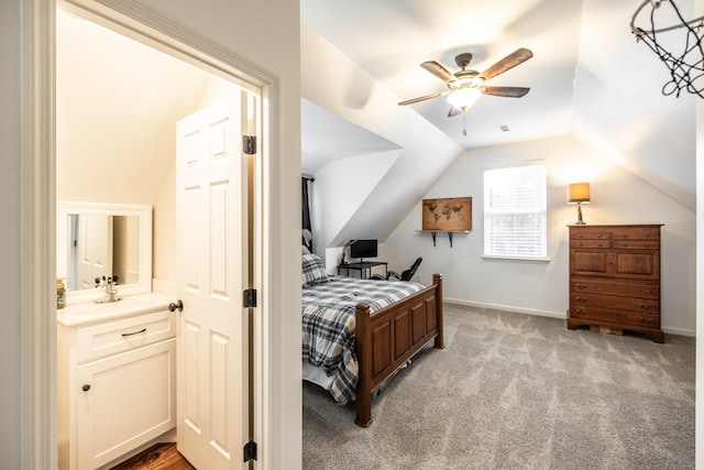 bedroom featuring light carpet, baseboards, visible vents, lofted ceiling, and a ceiling fan