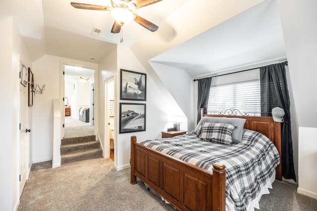 bedroom with light carpet, lofted ceiling, visible vents, and baseboards