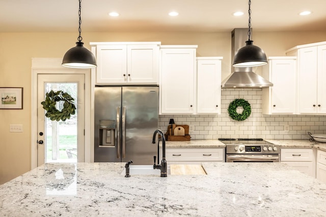 kitchen with decorative backsplash, appliances with stainless steel finishes, white cabinetry, and a sink