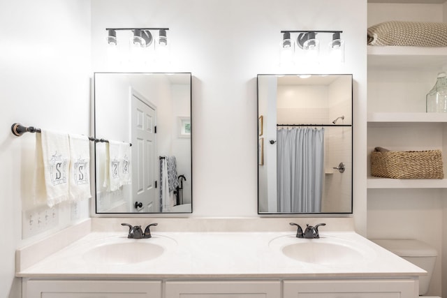full bath with toilet, a shower with curtain, a sink, and double vanity