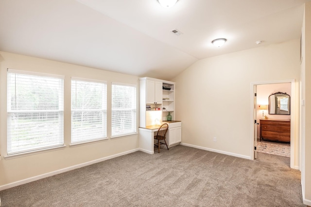 unfurnished bedroom with light carpet, lofted ceiling, multiple windows, and visible vents